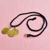 Flat lay image showing the full necklace length of 49.5 cm with clasp detail visible. Designed as a layering necklace or solo pendant, this piece works within minimalist jewelry collections and capsule wardrobes.