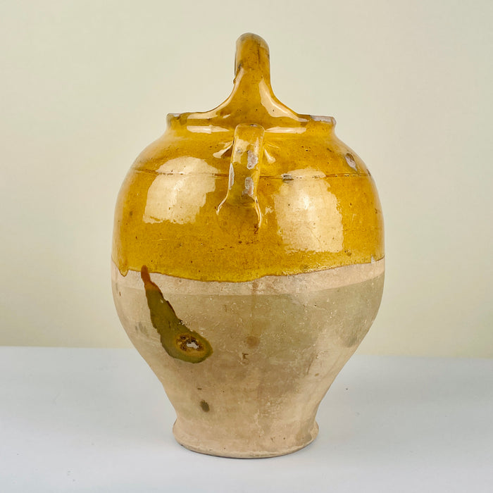 Antique French gargolette pottery jug illustrating its curvaceous profile and two-tone glaze. A timeless object of functional beauty, perfect for Mediterranean homes and rustic French Country Decor