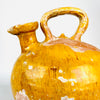 Overhead view of a very rare French cruche showing the relationship between its broad pinched mouth, strong handle and full ovoid terracotta body. The wide glazed opening and unusual asymmetrical construction distinguish this large yellow pottery water jug from conventional narrow-spouted gargoulettes.