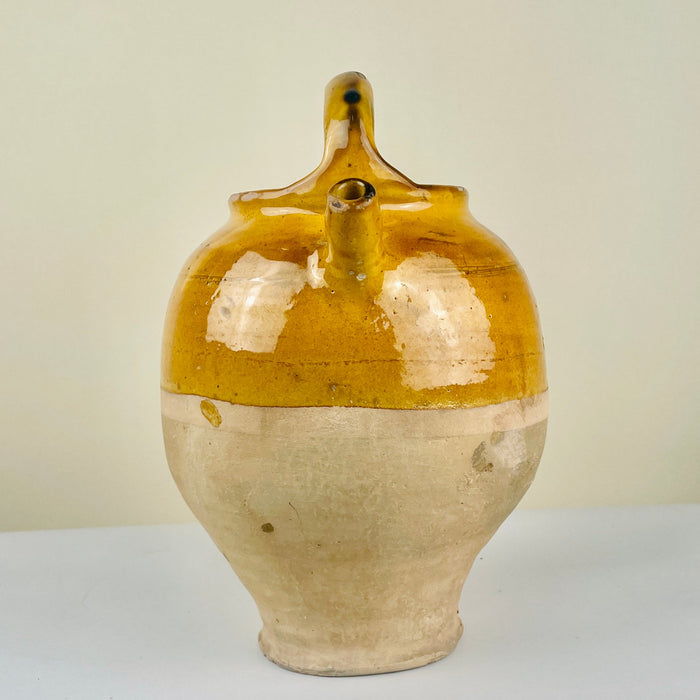 Close-up detailing and spout of antique yellow-glazed pottery jug. A fine example of Figeac pottery, historically used for cooling water or wine, now perfect for farmhouse table decor and cottage-style interiors.