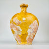 rare pinched spout on a large French gargoulette water jug. The wide asymmetric rim retains mustard-yellow glaze, firing speckles and natural wear, while small edge losses and exposed rose clay reveal the handmade construction of this unusual Provence terracotta vessel.