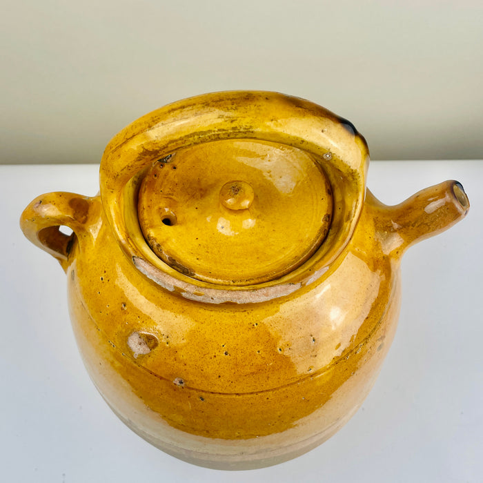 Antique French gargolette water pitcher in ochre glaze, hand-thrown with small spout and unglazed lower section. Traditional Southwest France pottery ideal for French Country Decor or wabi sabi decor, organic modern homes, and rustic collectors’ displays.