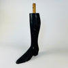 Single antique mannequin leg from France, carved in dense solid wood with a smoothly tapered calf and extended pointed boot. The rubbed black surface reveals warm natural timber at scratches and worn edges, and the round mounting dowel survives above the leg. This graphic Napoleon III object adds a figurative accent to eclectic decor.