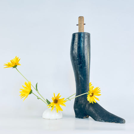 Napoleon III carved wood boot and lower mannequin leg from France, dating to the late nineteenth century. Its dense solid construction, dark rubbed finish, narrow ankle and elongated toe create a strong figurative silhouette, while scratches and exposed timber preserve its working history. An authentic accent for dark academia decor.