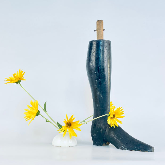 Napoleon III carved wood boot and lower mannequin leg from France, dating to the late nineteenth century. Its dense solid construction, dark rubbed finish, narrow ankle and elongated toe create a strong figurative silhouette, while scratches and exposed timber preserve its working history. An authentic accent for dark academia decor.