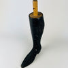 Single antique mannequin leg from France, carved in dense solid wood with a smoothly tapered calf and extended pointed boot. The rubbed black surface reveals warm natural timber at scratches and worn edges, and the round mounting dowel survives above the leg. This graphic Napoleon III object adds a figurative accent to eclectic decor.