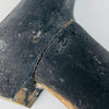 Underside of the elongated boot on a circa 1870–1890 French mannequin leg, revealing unpainted solid wood across the sole and heel base. Edge wear, shallow scratches, faint pencil numerals and dark paint remnants document its age and use. This honest construction detail supports its identity as an antique mannequin fragment for eclectic decor.