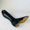 Rare circa 1870–1890 French mannequin lower leg with an exposed wooden dowel and short transverse metal pin for attachment to a full figure. The black painted solid wood has a hand shaped calf, sculpted ankle, elongated boot and low heel. Its preserved construction and age worn finish suit collected Napoleon III decor.