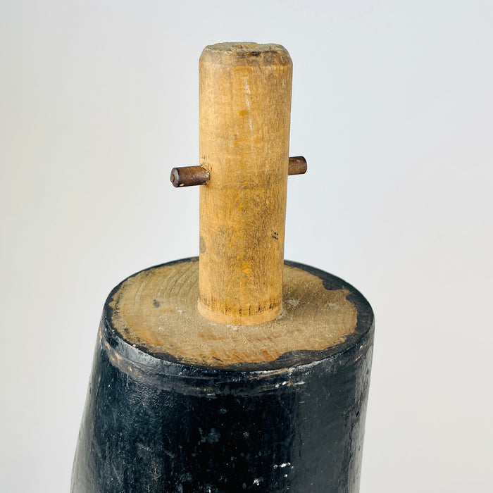 Construction detail on an antique French wooden mannequin leg reveals the pronounced open separation where the carved boot joins the ankle and heel. Small round holes, scratches, rubbed black paint and exposed pale timber are clearly present. These authentic signs of age give the nineteenth century fragment particular appeal for oddities decor.
