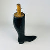 Antique French wooden mannequin leg dating to circa 1870–1890, carved with a slender calf, sharply defined ankle and unusually long black boot. Heavy wear exposes pale wood through the dark painted finish, while the tall silhouette and surviving mounting hardware retain the character of a working trade object for dark academia decor.