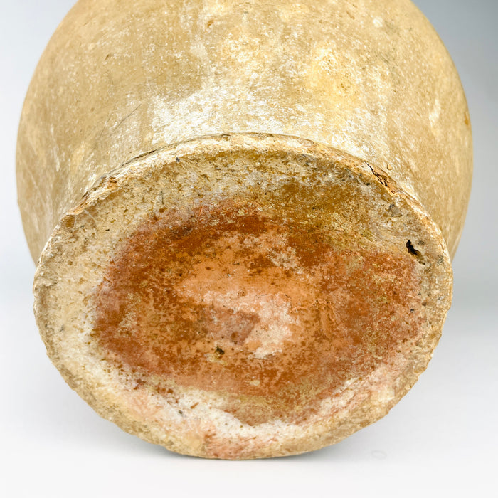 Traditional French confit jar in yellow glazed terracotta, originally used for preserving meat in rendered fat and stored in a cool larder or partly below ground. The glazed upper half, weathered lower body and robust handles connect historic kitchen function with Mediterranean decor.