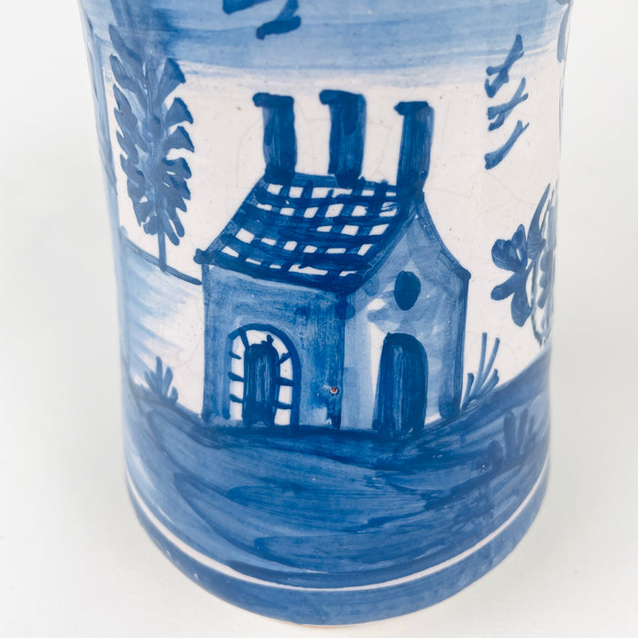 Ceramic Apothecary jar vase with blue and white design of a house and trees on a white background