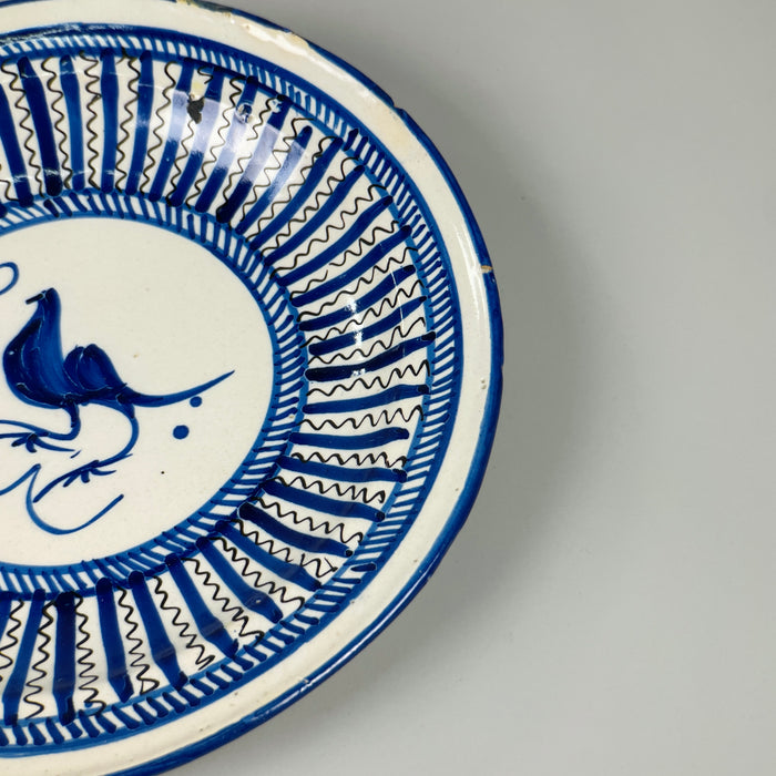Side profile of antique Manises ceramic plate, showing shallow bowl shape, 3.4 cm in height, hand-painted in radial cobalt blue and ideal for hanging in vintage rustic kitchen or gallery wall.