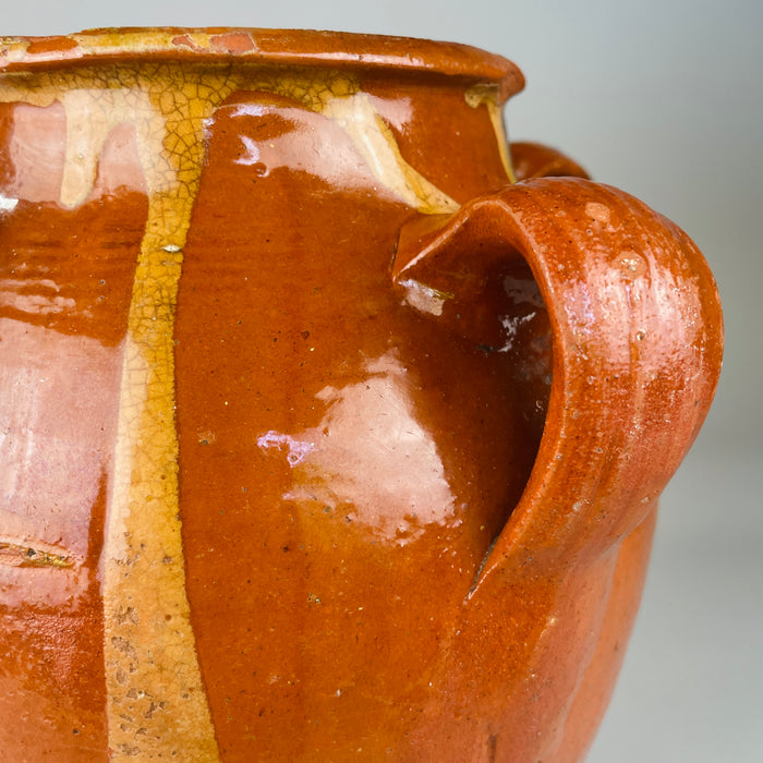 Glaze close-up with crackling and color variation on red terracotta surface of early 20th-century Spanish jar, reflecting wabi-sabi aesthetics and handcrafted pottery from Toledo, perfect for curated ceramic collections.