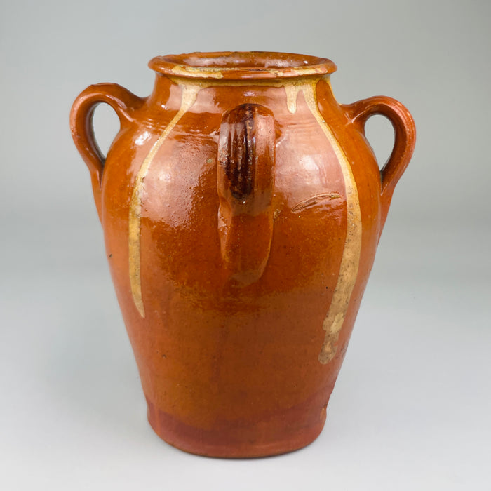 Early 20th-century Spanish glazed jar with four sculptural handles and tall form, showcasing utilitarian craftsmanship and decorative glazing typical of central Spain's terracotta pottery production in the rural artisan tradition