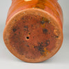Underside view of antique Spanish vessel with single ventilation hole and dark firing marks, highlighting traditional kiln techniques and authentic wear typical of hand-thrown terracotta pottery from central Spain.