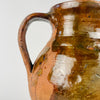Nineteenth century Spanish terracotta vase showing glossy honey brown glaze, irregular glaze loss, exposed orange red clay and small firing marks. These authentic age related variations give the Castilian orza pottery jar a strong wabi sabi quality while preserving its clear identity as an antique Spanish storage vessel.
