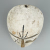 Tribal face art mask shown in full silhouette, hand-carved and coated in white pigment, representing ceremonial wall sculptures from Fang and Kwele cultures, used in wabi-sabi or cultural design interiors.