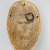 Back view of hollow African wood mask showing drilled holes and hand-carved interior, photographed to showcase construction for mounting, traditional ceremonial influence, and rustic wall art styling options.