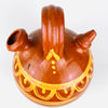 Hand painted glazed Spanish botijo in terracotta with a rounded body and narrow base, made for cooling water through porous clay construction. 
 The lower portion remains unglazed and timeworn, emphasizing its utilitarian history. This antique water jug fits farmhouse decor, rustic home decor, and antique pottery collections focused on Spanish ceramic.
