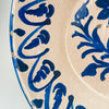 Nineteenth century Spanish Fajalauza lebrillo bowl from Granada with hand painted cobalt blue decoration, cream-white glaze, and a substantial earthenware body weighing 2121 grams. The bowl shows floral brushwork at the center and repeated curved motifs around the inner wall, with minor rim losses and surface crazing consistent with age. It is suitable as a decorative bowl or centerpiece bowl in Mediterranean decor, wabi sabi decor, and Spanish pottery displays.