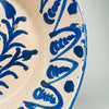 Antique Granada pottery bowl in Spanish Fajalauza earthenware, with a wide circular form, rounded base, and blue floral motif painted by hand across the interior. The cream-white glaze and cobalt blue palette are consistent with traditional Fajalauza ceramics, while visible chips and glaze variation support its age. This lebrillo bowl can be displayed flat on a table or upright with a hanger as wall hanging ceramic in rustic home decor and Mediterranean decor.