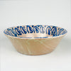 Antique Fajalauza bowl from Granada, Spain, with a floral motif painted by hand in cobalt blue over a pale tin glazed ground. The bowl has a generous 31.5 cm width, a shallow-deep lebrillo profile, and visible terracotta beneath small glaze losses at the rim and interior. This Spanish pottery piece can be styled as a centerpiece bowl, decorative bowl, or wall display ceramic in rustic home decor, wabi sabi decor, and vintage home decor.