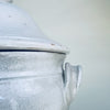 Vintage French pedestal bowl with a domed lid and symmetrical handles, crafted in thick white glazed earthenware and sourced in Provence. The large lidded form works as a decorative centerpiece on a console, dining table, or open shelving, complementing Mediterranean decor and French farmhouse decor.