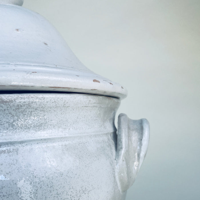 Vintage French pedestal bowl with a domed lid and symmetrical handles, crafted in thick white glazed earthenware and sourced in Provence. The large lidded form works as a decorative centerpiece on a console, dining table, or open shelving, complementing Mediterranean decor and French farmhouse decor.