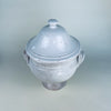 French white pottery tureen with lid, displaying a softly mottled glaze, subtle clay colour beneath the worn surface, and a substantial pedestal base. The large decorative bowl can be styled empty as a sculptural object or used with dried branches on a console, sideboard, or farmhouse decor table.