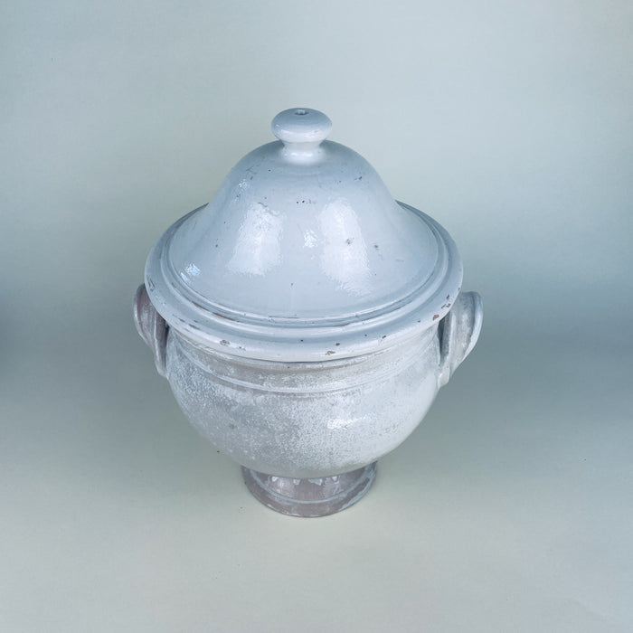 French white pottery tureen with lid, displaying a softly mottled glaze, subtle clay colour beneath the worn surface, and a substantial pedestal base. The large decorative bowl can be styled empty as a sculptural object or used with dried branches on a console, sideboard, or farmhouse decor table.
