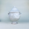 White ceramic pedestal tureen with its domed lid removed, revealing the deep glazed interior and substantial rim of the French earthenware body. The two handled lidded bowl retains a sculptural serving form while its timeworn finish makes it especially suited to decorative storage, dried botanicals, or rustic home decor.