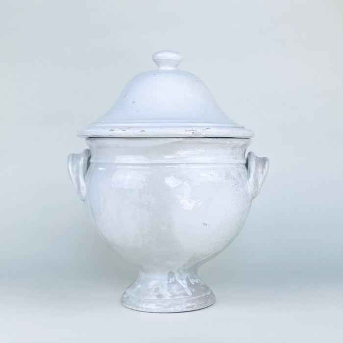 Large vintage French decorative bowl in white glazed earthenware, formed as a pedestal tureen with a fitted domed lid, rounded finial, twin loop handles, and broad circular foot. The softly timeworn white surface and sculptural 35 cm scale suit French country decor, farmhouse decor, or a console centerpiece.
