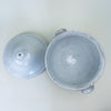 Vintage French soup tureen presented as a large decorative bowl, with white glazed ceramic construction, a fitted cover, twin handles, and a raised pedestal base. Measuring 35 cm tall, the piece has the scale of a statement vessel for farmhouse decor, French provincial decor, or a collected kitchen display.
