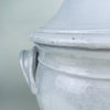 French white ceramic decorative bowl in a traditional pedestal tureen form, with a deep rounded body, fitted lid, mushroom shaped knob, and two applied loop handles. The mottled white glaze reveals traces of warm terracotta beneath, creating a timeworn surface suited to wabi sabi decor and rustic home decor.