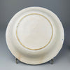 Back view of Spanish ceramic plate showing unglazed base and firing ring, providing insight into traditional Manises pottery techniques and historical ceramic production.