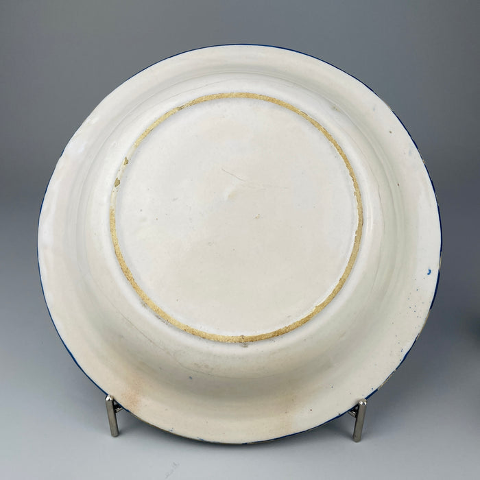 Back view of Spanish ceramic plate showing unglazed base and firing ring, providing insight into traditional Manises pottery techniques and historical ceramic production.