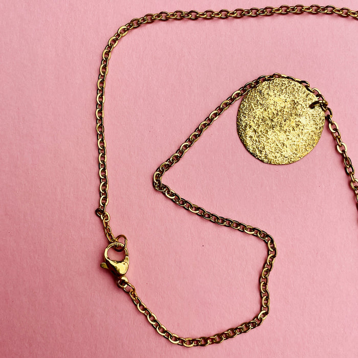 Artisan Mediterranean necklace featuring hammered coin discs, gold-tone alloy chain, and spring-ring clasp. A layering necklace designed for contemporary fashion styling, minimalist wardrobes, and summer resort collections.