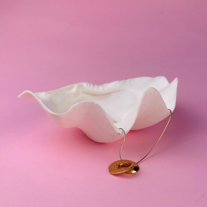 Minimalist art pendant crafted as a wearable sculpture, plated in gold over bronze. Hand-carved in wax by Laragh Stuart, this pendant reflects the lost-wax tradition. Ideal for modern jewelry collectors, gallery-inspired fashion, and contemporary design enthusiasts.