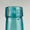 This Spanish blue glass demijohn by Viresa combines utility history with decorative appeal. Originally a wine carboy bottle, it is made in hand blown glass with visible bubble inclusions, a rounded belly, and narrow neck. Today it reads as a large sculptural vase suited to Mediterranean decor, coastal decor, and rustic home decor interiors.