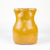 Spanish folk pottery pitcher from La Rioja with a glossy yellow glaze, broad rounded proportions and a tall applied handle. The 19th century jug retains authentic chips, glaze losses, surface rubbing and exposed terracotta around the rim and body, creating a naturally timeworn appearance suited to farmhouse decor, rustic shelving and pottery collections.