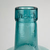 Vintage Spanish blue green glass demijohn with embossed Viresa neck, hand blown construction, and a classic wine carboy silhouette. The strong rounded form, visible melt lines, and handmade bubble inclusions give this bottle authentic character, making it a practical decorative vase for olive branches, dried stems, or standalone display.