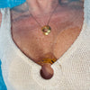 Handcrafted pendant with sculptural design, gold-plated bronze surface, and asymmetrical circular shape. Created as wearable sculpture and art jewelry, it was carved in wax and cast through the lost-wax method. Ideal for capsule wardrobes and minimalist fashion collections.
