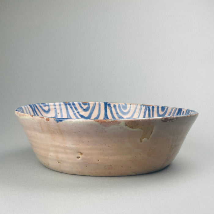 Blue and white vintage Spanish ceramic plate hand-painted with bird and floral motifs, early 20th-century craftsmanship.