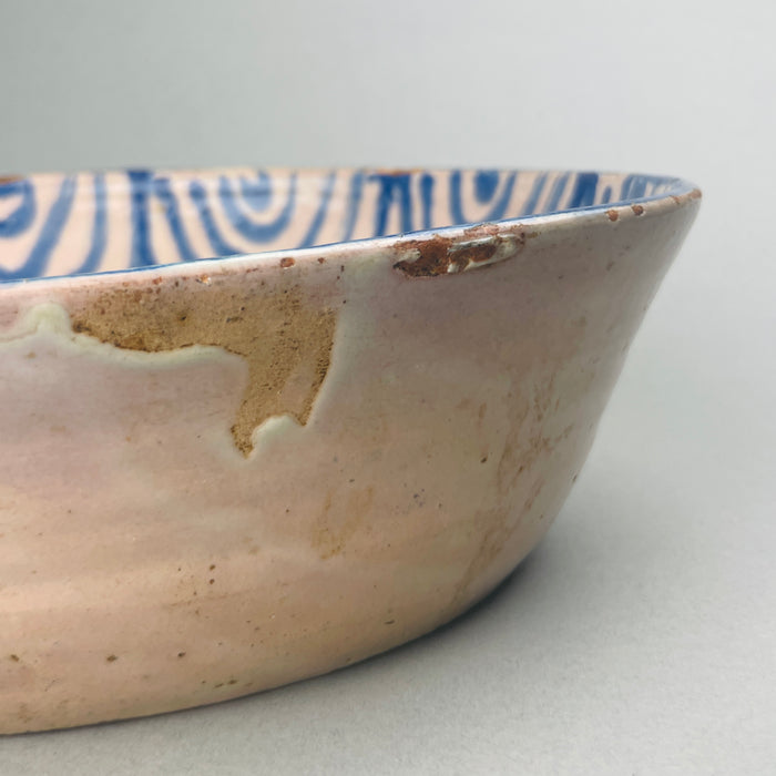 Hand-thrown Spanish pottery bowl with rustic patina, ideal for Mediterranean-style interior decoration or farmhouse kitchens.