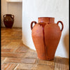 Early 20th century Spanish terracotta vase with XL scale, red clay body, ochre glaze drips, broad rounded form, and worn unglazed underside. The heavy pottery vessel is decorative rather than delicate, making it useful as a floor vase, statement pottery jar, Mediterranean decor accent, or rustic home decor focal point.