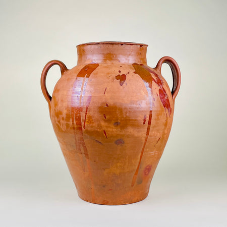 Large Spanish terracotta floor vase with two raised loop handles, warm ochre and reddish brown glaze runs, visible throwing lines, and a substantial 8.2 kg weight. The antique pottery vessel measures 43 cm high and suits entryway decor, fireplace styling, dried branch display, Mediterranean decor, and rustic farmhouse decor.