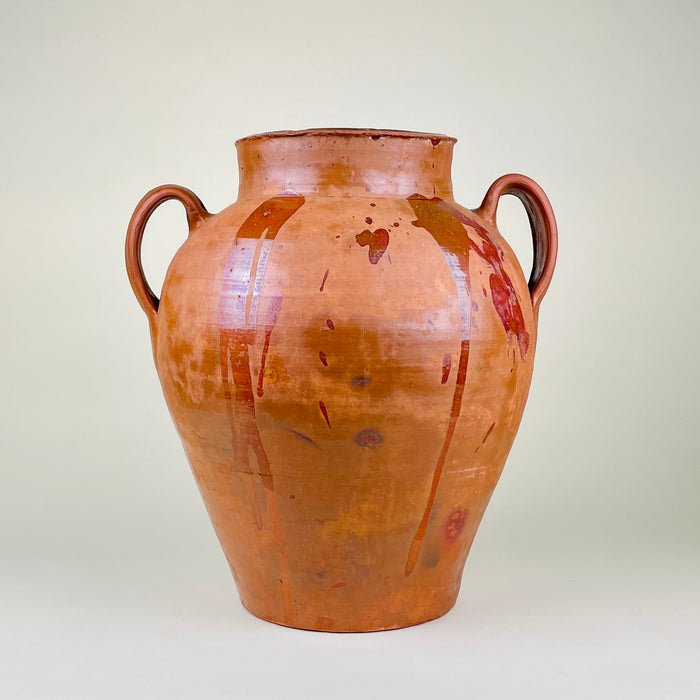 Large Spanish terracotta floor vase with two raised loop handles, warm ochre and reddish brown glaze runs, visible throwing lines, and a substantial 8.2 kg weight. The antique pottery vessel measures 43 cm high and suits entryway decor, fireplace styling, dried branch display, Mediterranean decor, and rustic farmhouse decor.