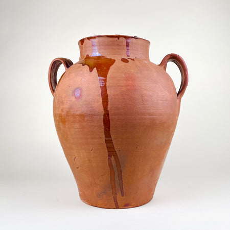 Antique XL decorative terracotta vase from Spain, made as a large two handle pottery vessel with red-orange earthenware clay, amber glaze drips, rounded body, wide neck, and visible age-related patina. This Spanish pottery floor vase works as Mediterranean decor, rustic home decor, farmhouse decor, and a sculptural floor vessel.