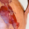Large Spanish pottery floor vessel with warm terracotta clay, semi-glazed amber surface, two curved handles, visible throwing rings, and aged patina across the body and base. This antique decorative jar works as a dried branch vase, entryway accent, fireplace object, or sculptural terracotta pot in farmhouse decor.